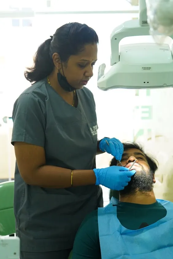 Dr. Jyothi Sajjan treating a patient at Apex Dental clinic